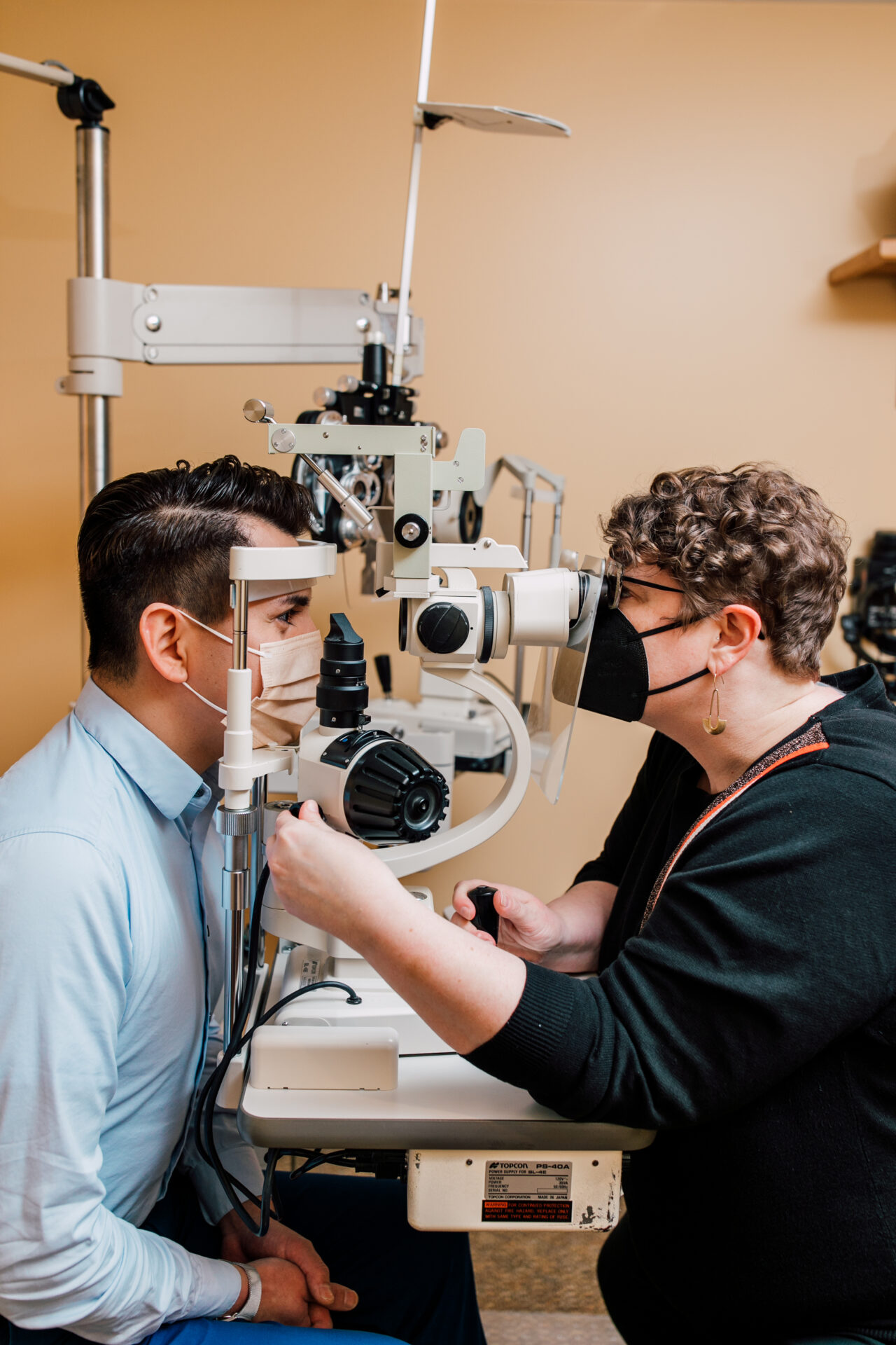 optometrist performing a medical eye exam at Binyon Vision Center in Bellingham, WA.  Looking at retina, glaucoma pressure, cataracts, diabetic changes.
